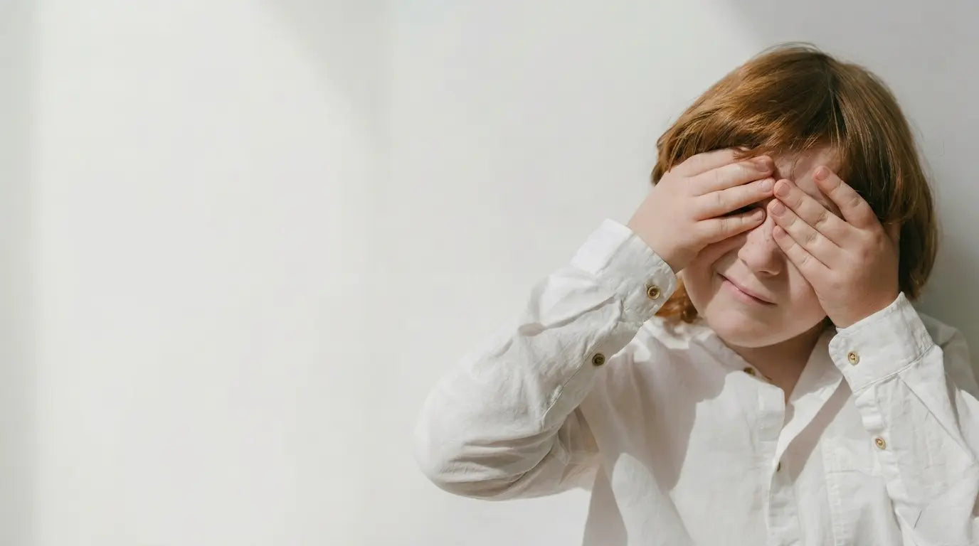 Person wearing a white shirt with a plain background